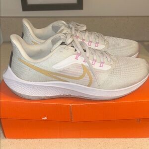 Nike Women's Zoom Pegasus - White and Gold with Pink Accents.